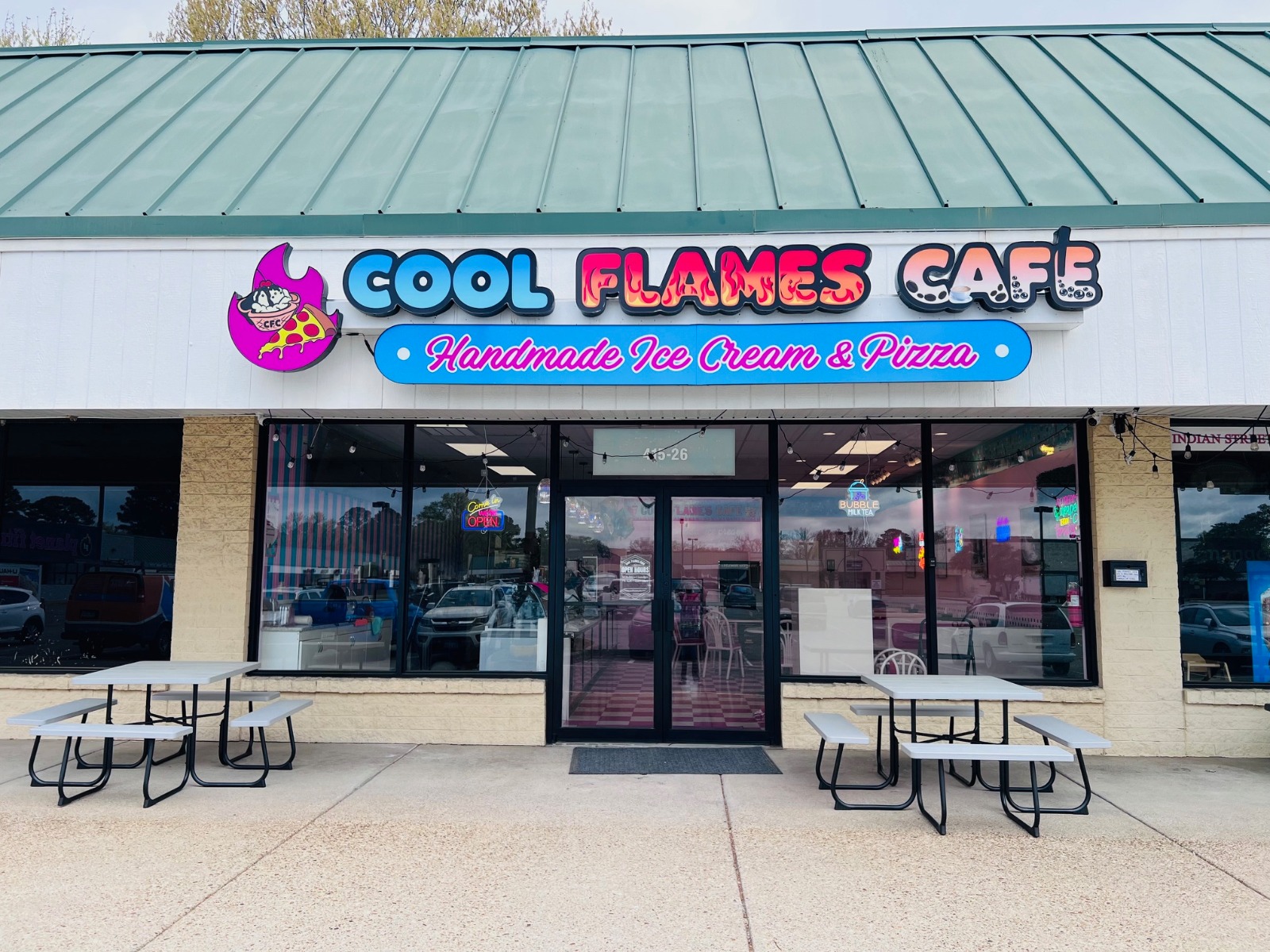 Cool Flames Cafe restaurant exterior storefront with outdoor seating advertising handmade ice cream and pizza.